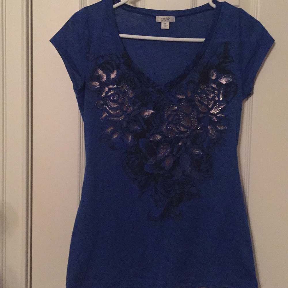 Cache Blue shirt w/ a Gold Floral Design. Size M.